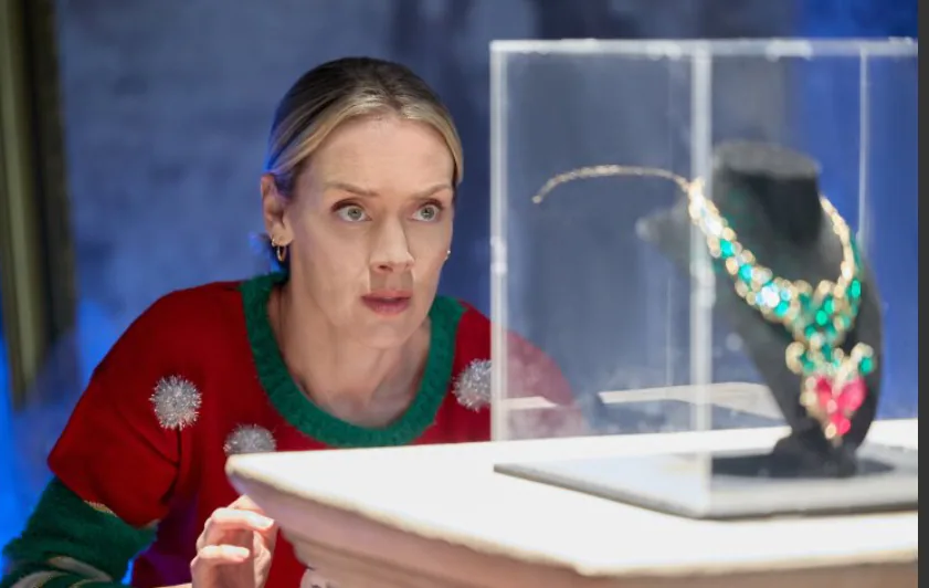 Still from The Christmas Charade (2024) featuring the holiday charity ball setting
